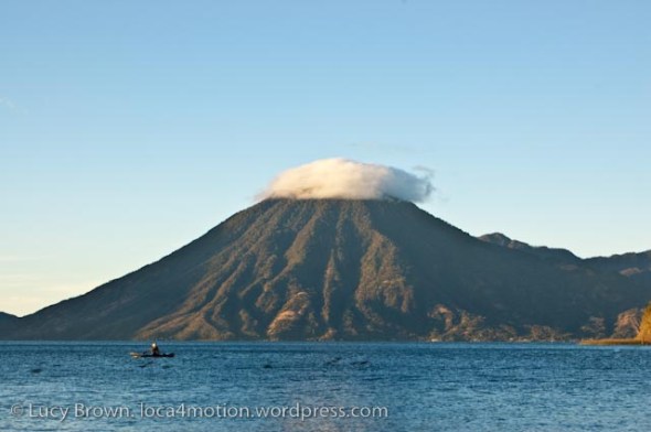 Early morning view of fisherman and Volcán San Pedro on Christmas Eve, Lago de Atitlán, Guatemala