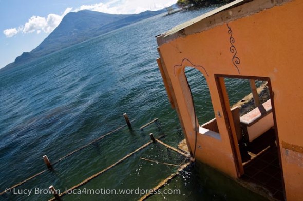 Flooded building on edge of lake with Volcán Tolimán on horizon, Christmas Eve, Lago de Atitlán, Guatemala