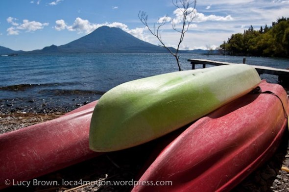Canoes on edge of lake with Volcán Tolimán on horizon, Christmas Eve, Lago de Atitlán, Guatemala
