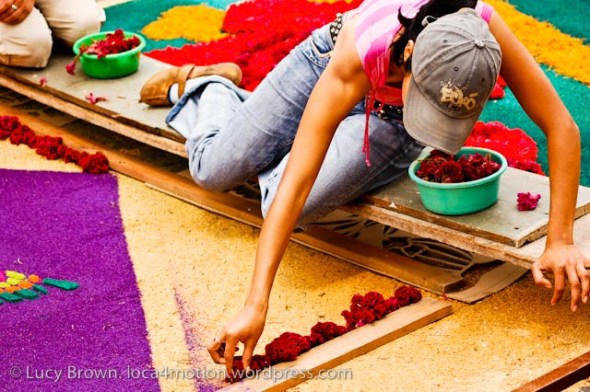 Lying on raised wooden planks to decorate and avoid damaging alfombras, Antigua, Guatemala
