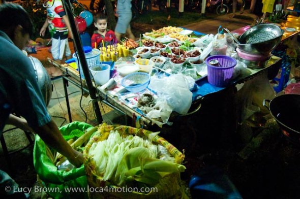Cart with medley of sausages and fries, street food, Thailand