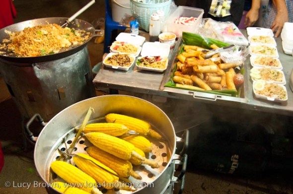 Fried rice, fried noodles, spring rolls and corn, street food, Thailand