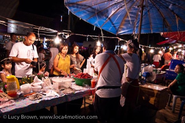 Selling plastic cups filled with strawberries drenched in sugar, street food, Thailand