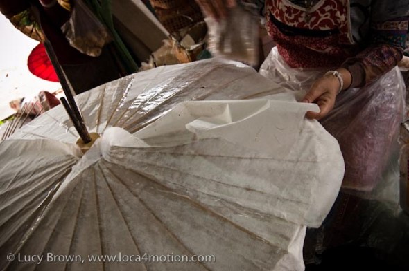Glueing layers of sa paper to parasol frame, traditional Thai parasols, Chiang Mai, Thailand