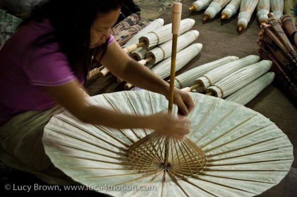 Fixing bamboo spokes on parasol, traditional Thai parasols, Chiang Mai, Thailand