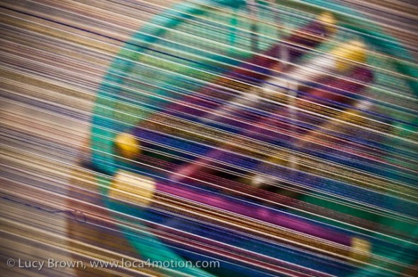 Close-up of spindles of Thai silk thread seen through threads on loom, Chiang Mai, Thailand