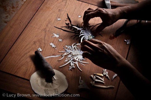 Inserting mother-of-pearl inlay in rosewood, wood carving, Chiang Mai, Thailand