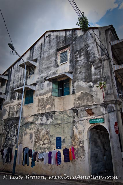 Old building with washing line in the street, George Town, Penang, Malaysia
