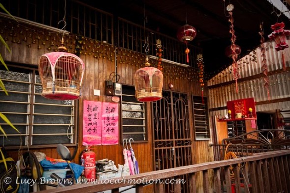 Jetty home with hanging bird cages and Chinese shrine, Chew Jetty, Clan Jetties, George Town, Penang, Malaysia
