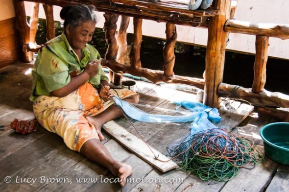 Local woman mending fishing nets, Koh Panyee (Ko Panyi), Phang Nga Bay, Thailand