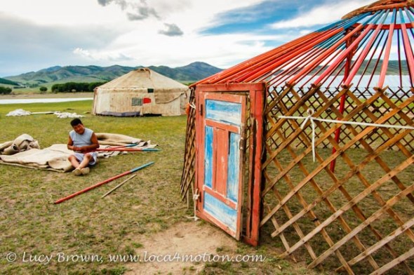 Contructing a Mongolian ger. Wooden wall lattice, roof poles and door. Khutag Ondor, Central Mongolia